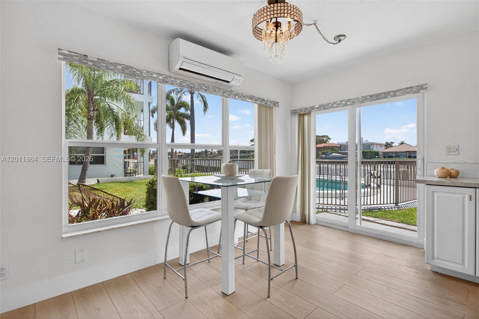 615 South Riverside Drive, Unit 5 Pompano Beach, FL 33062 - Photo 5 of 29 a view of a dining room with furniture large window and wooden floor