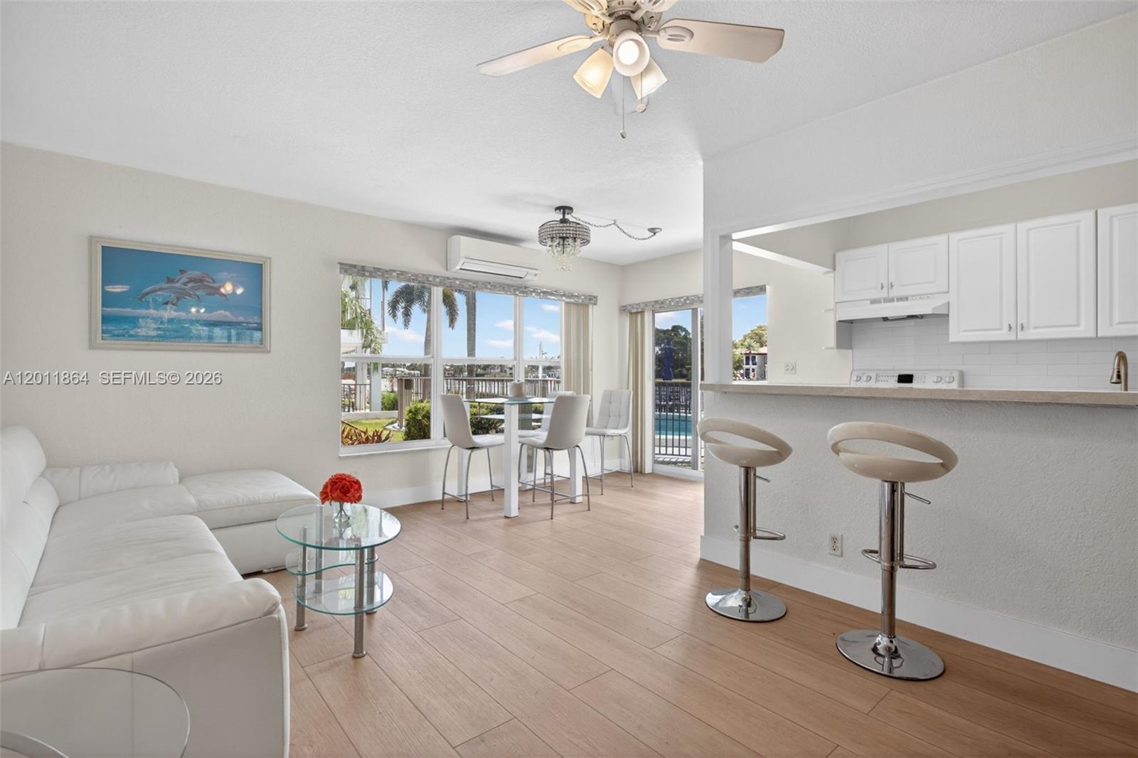 615 South Riverside Drive, Unit 5 Pompano Beach, FL 33062 - Photo 6 of 29 a living room with furniture and kitchen chandelier
