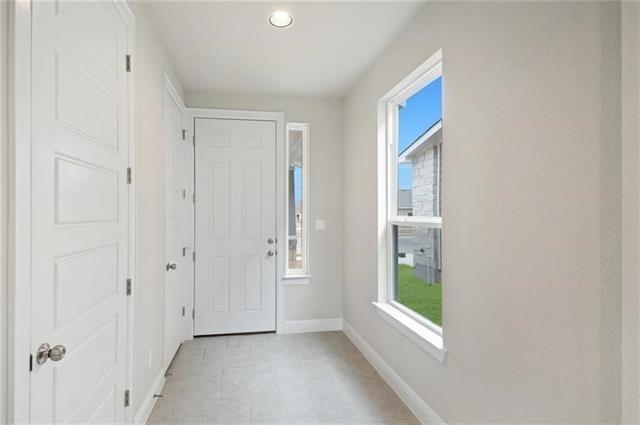 Foyer featuring baseboards and recessed lighting