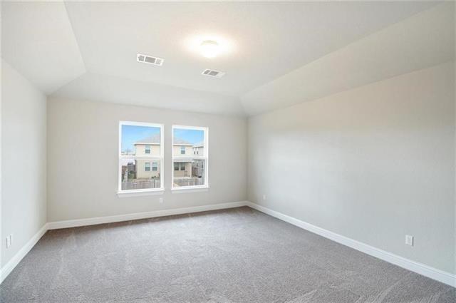 113 Gaida Loop Georgetown, TX 78628 - Photo 13 of 23 Unfurnished room featuring light colored carpet and lofted ceiling