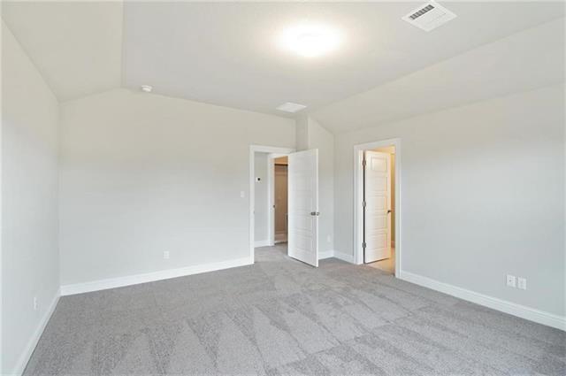 113 Gaida Loop Georgetown, TX 78628 - Photo 15 of 23 Spare room featuring lofted ceiling and light carpet