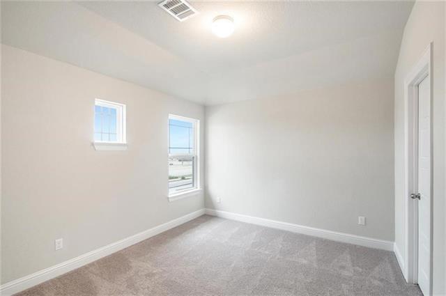 113 Gaida Loop Georgetown, TX 78628 - Photo 20 of 23 Spare room with light colored carpet and baseboards