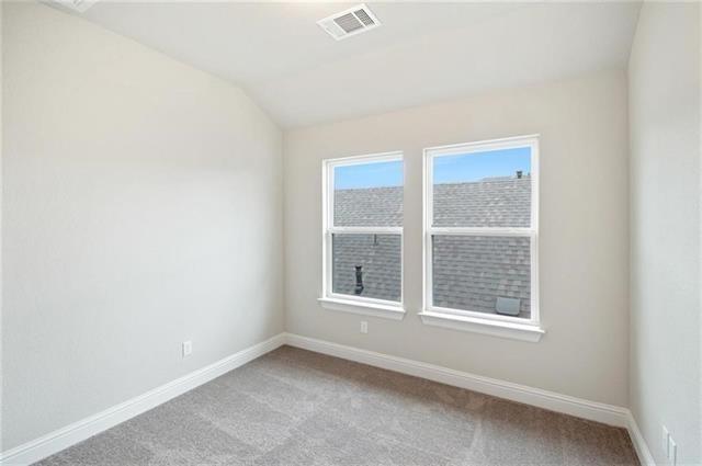 113 Gaida Loop Georgetown, TX 78628 - Photo 21 of 23 Unfurnished room featuring light colored carpet and vaulted ceiling