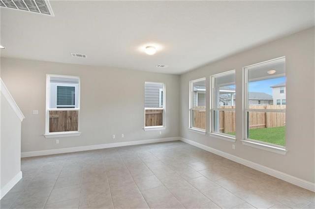 113 Gaida Loop Georgetown, TX 78628 - Photo 3 of 23 Unfurnished room with baseboards and light tile patterned floors