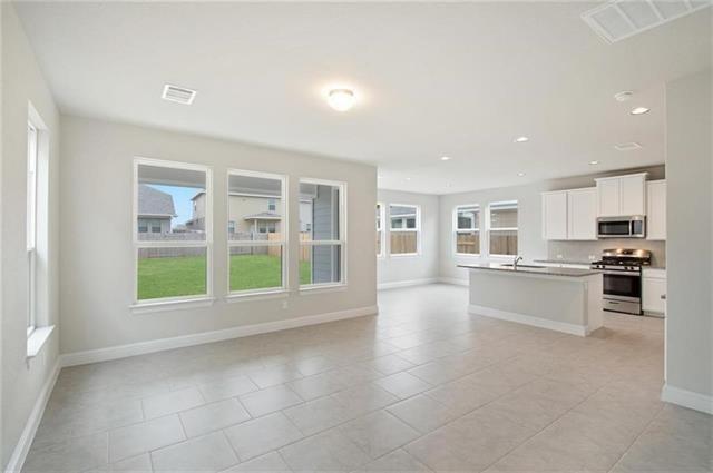 113 Gaida Loop Georgetown, TX 78628 - Photo 6 of 23 Unfurnished living room with recessed lighting and light tile patterned flooring