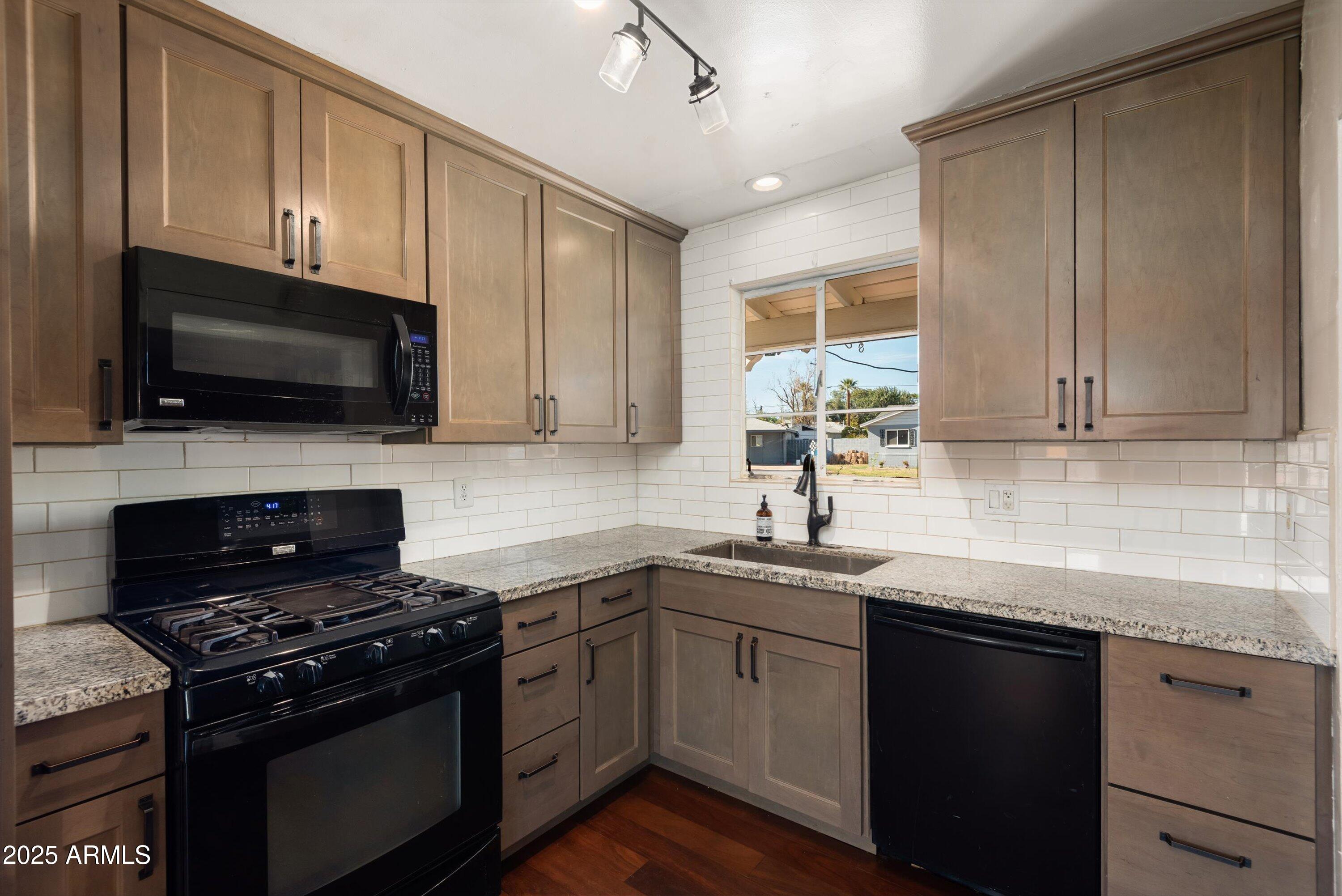 2217 West Gardenia Drive Phoenix, AZ 85021 - Photo 11 of 32 a kitchen with a sink stove and microwave