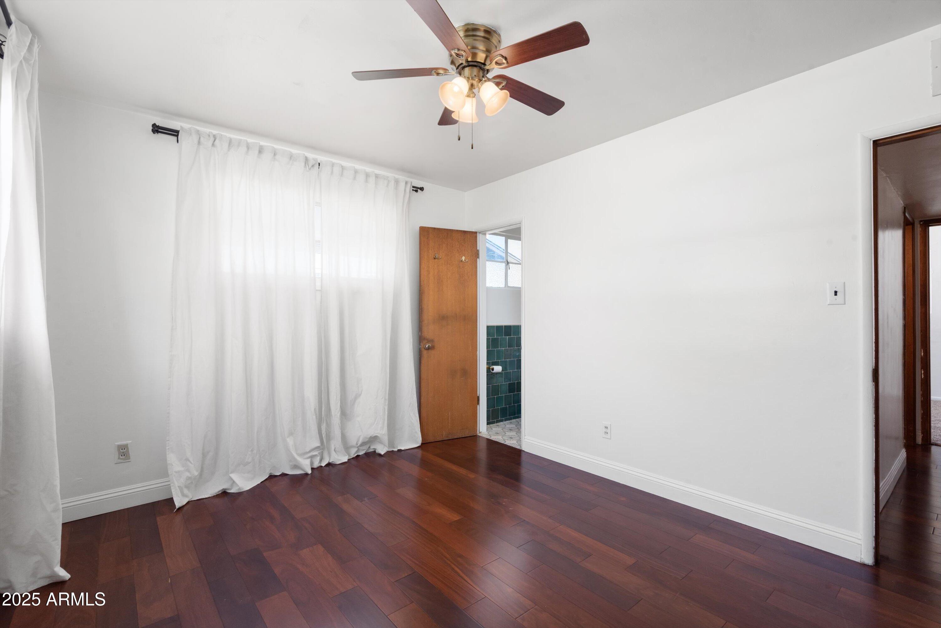 2217 West Gardenia Drive Phoenix, AZ 85021 - Photo 14 of 32 an empty room with wooden floor and windows