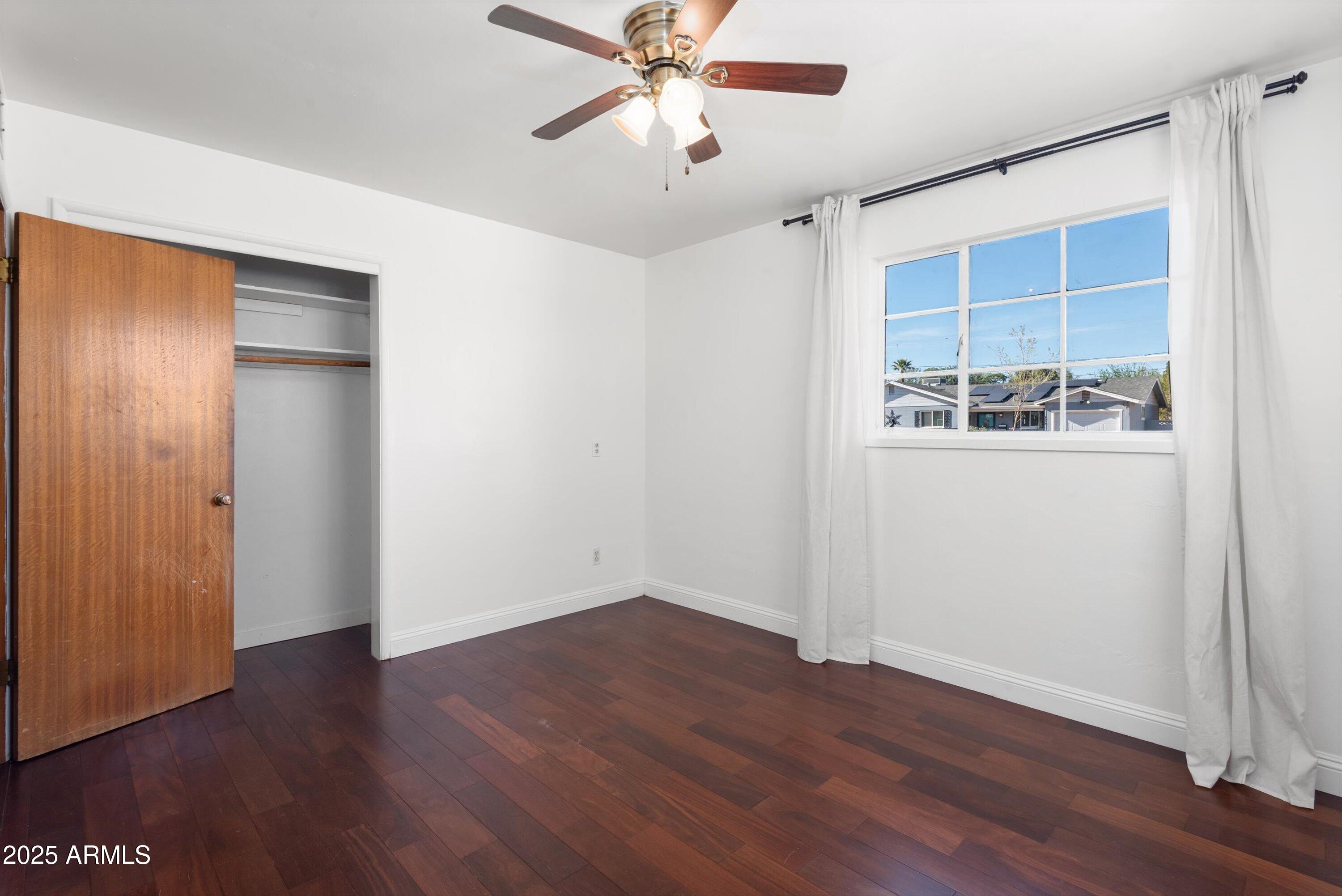 2217 West Gardenia Drive Phoenix, AZ 85021 - Photo 15 of 32 wooden floor in an empty room with a window