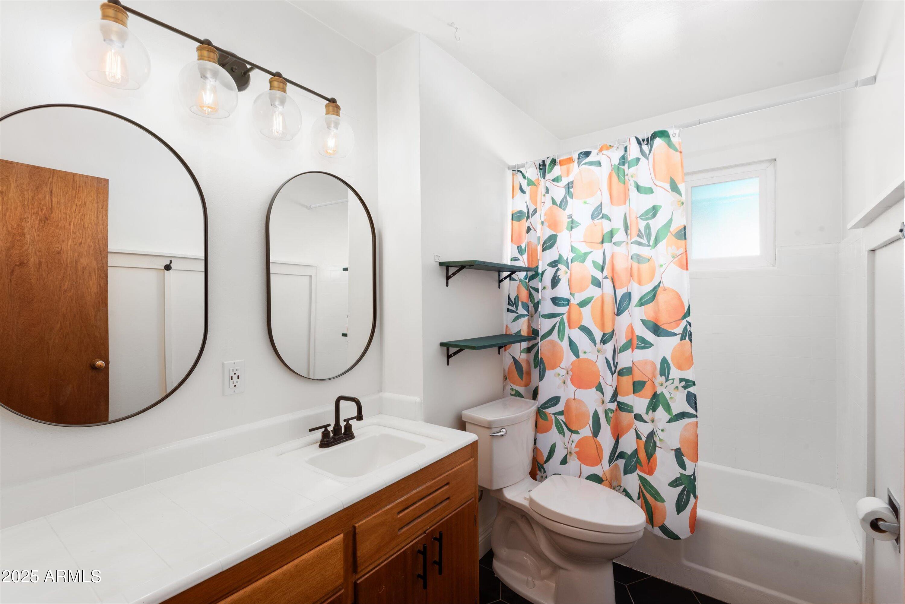 2217 West Gardenia Drive Phoenix, AZ 85021 - Photo 19 of 32 a bathroom with a sink toilet and shower