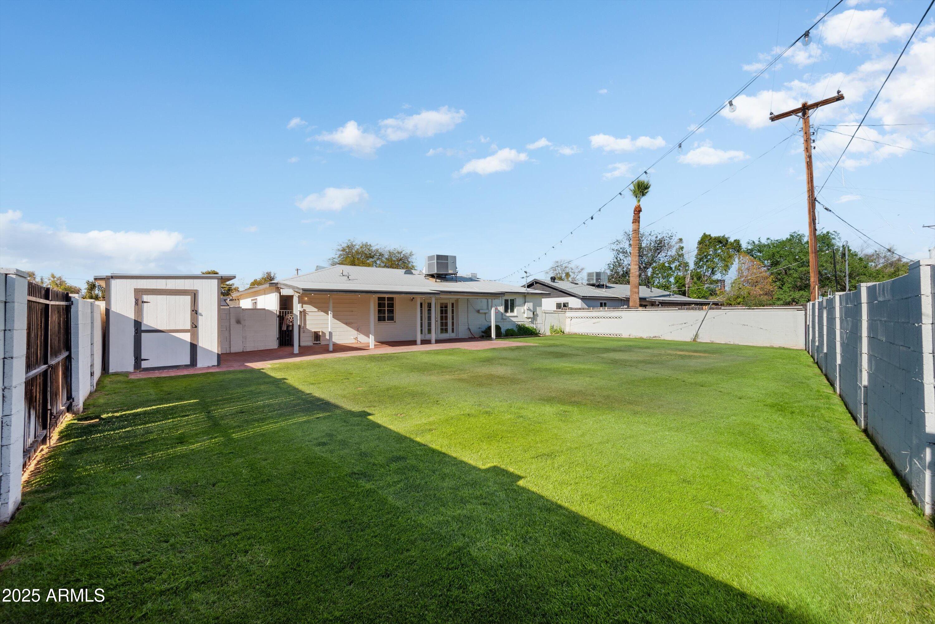 2217 West Gardenia Drive Phoenix, AZ 85021 - Photo 28 of 32 a view of a house with a big yard and a large tree
