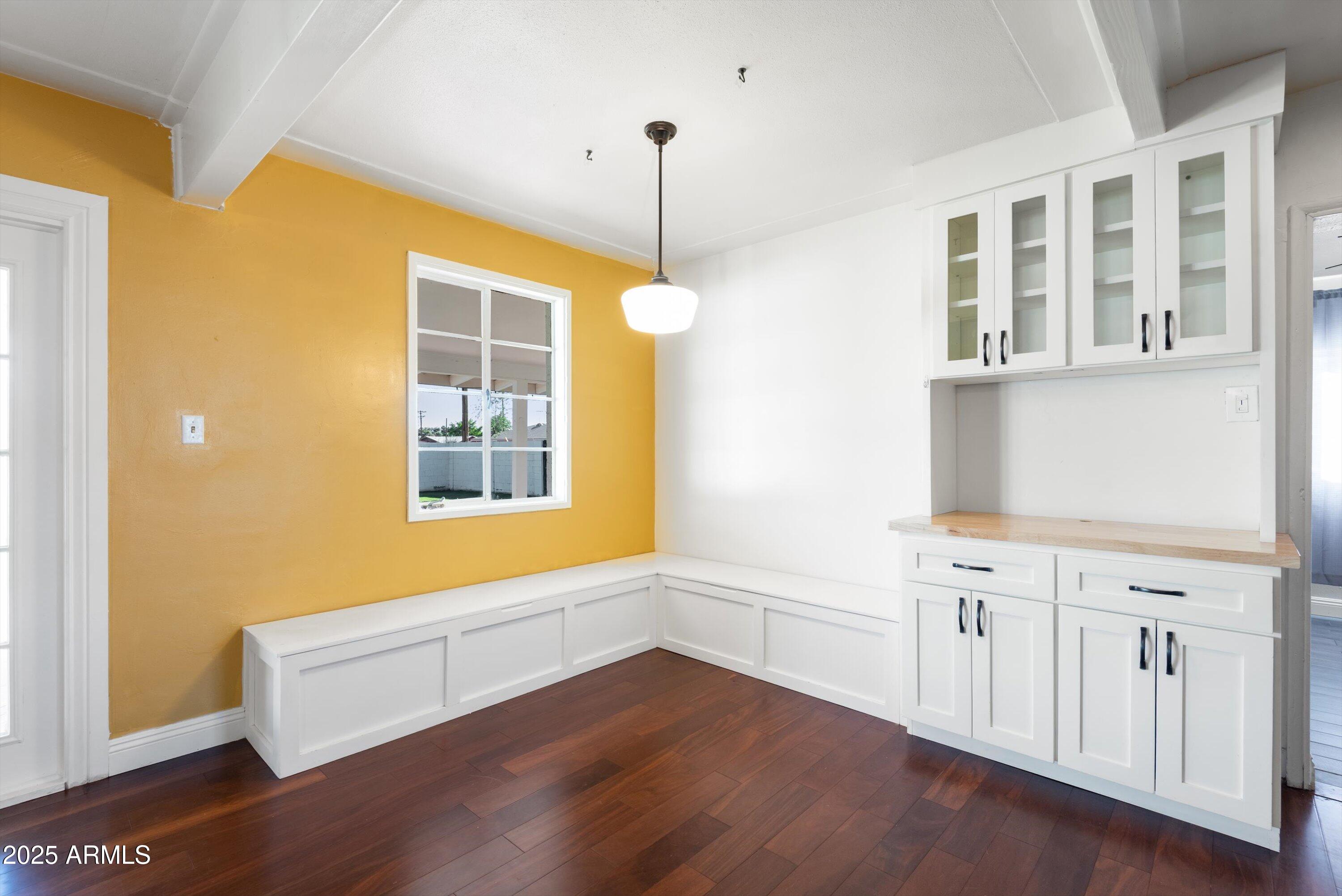 2217 West Gardenia Drive Phoenix, AZ 85021 - Photo 6 of 32 a view of an empty room with wooden floor and a window