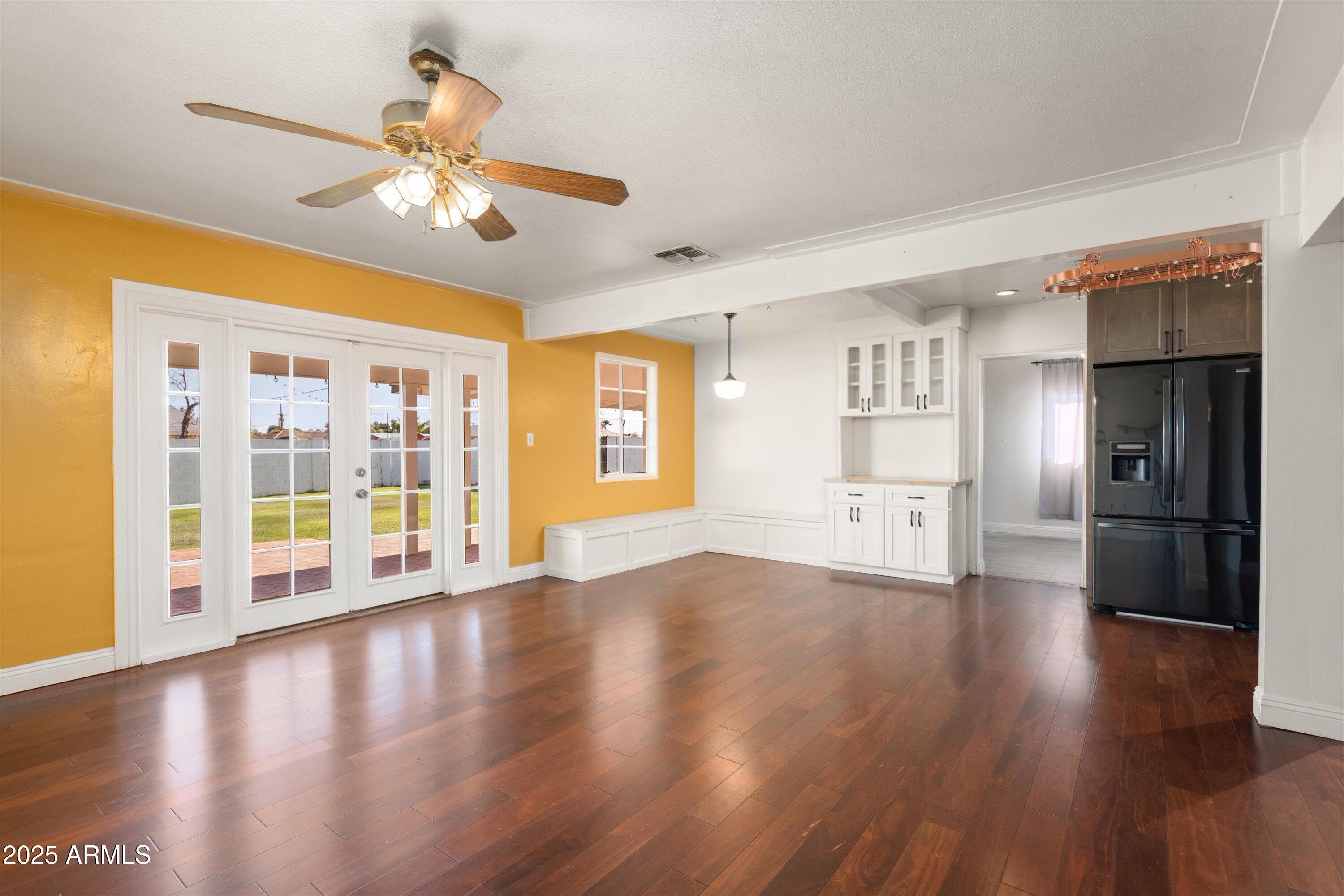 2217 West Gardenia Drive Phoenix, AZ 85021 - Photo 7 of 32 a view of an empty room with window and wooden floor