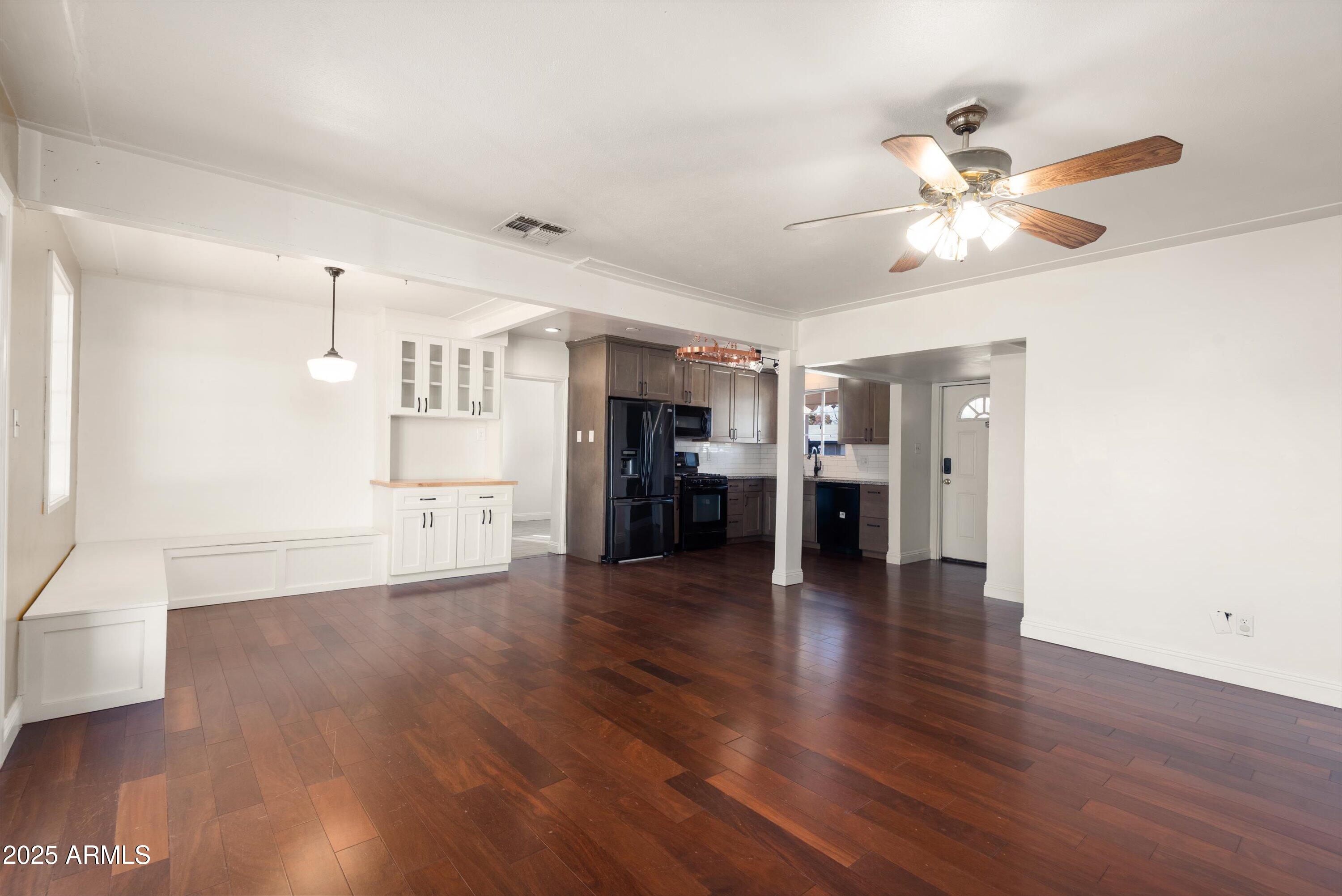2217 West Gardenia Drive Phoenix, AZ 85021 - Photo 8 of 32 a view of a kitchen with wooden floor and a refrigerator
