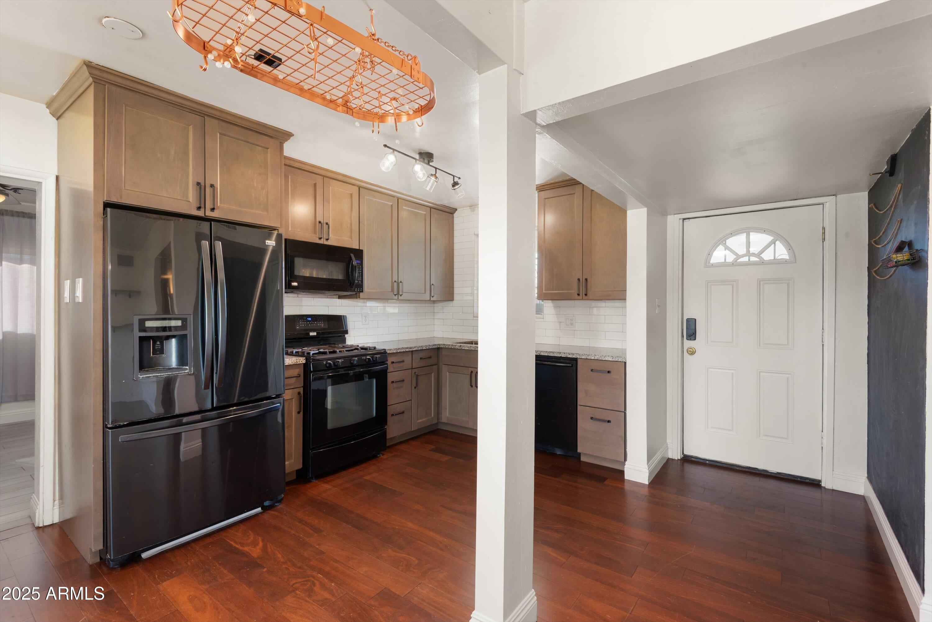 2217 West Gardenia Drive Phoenix, AZ 85021 - Photo 9 of 32 a kitchen with a refrigerator and a stove top oven
