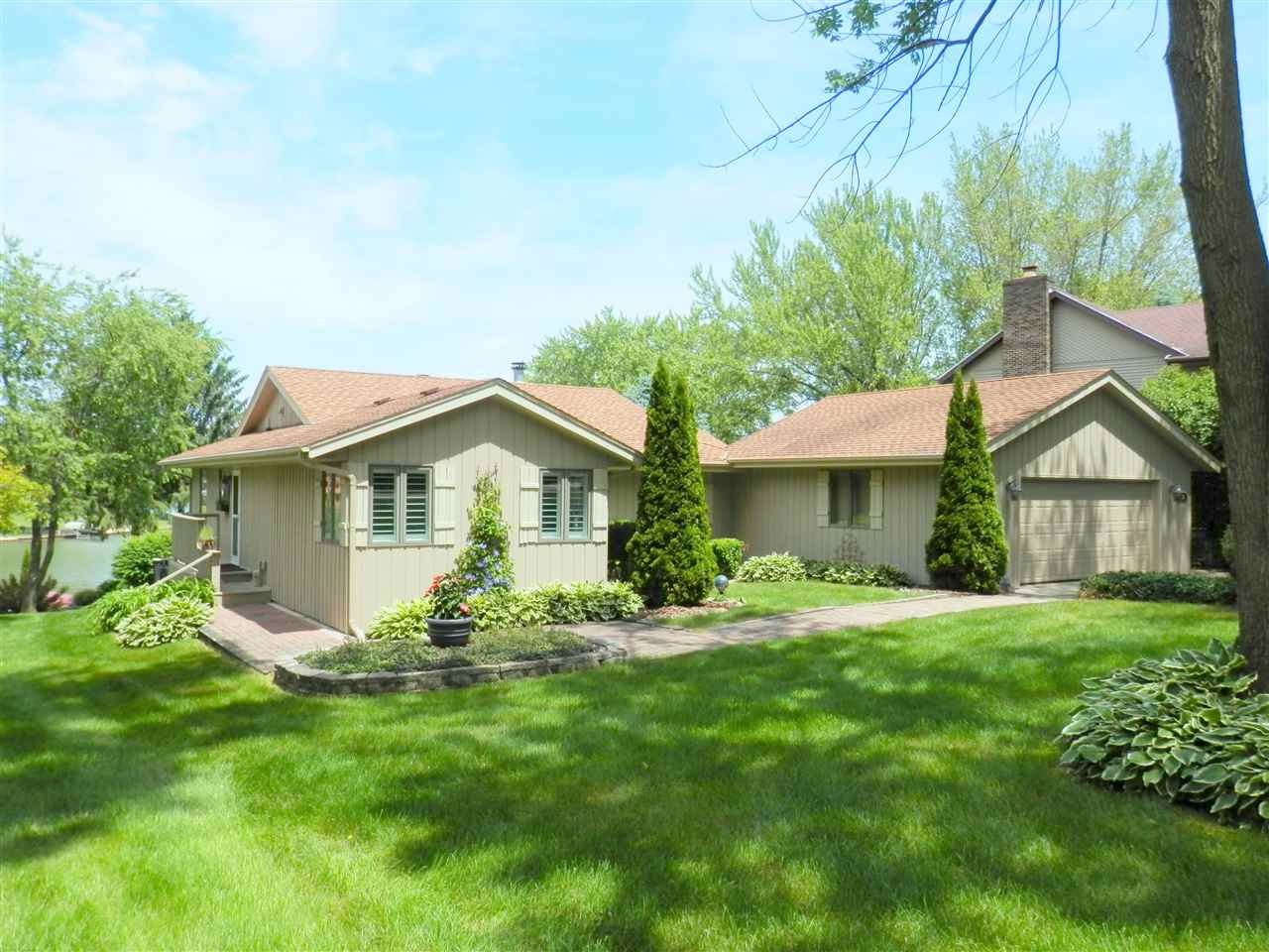 512 Baintree Road Lake Summerset, IL 61019 - Photo 2 of 25 a front view of a house with a garden and yard