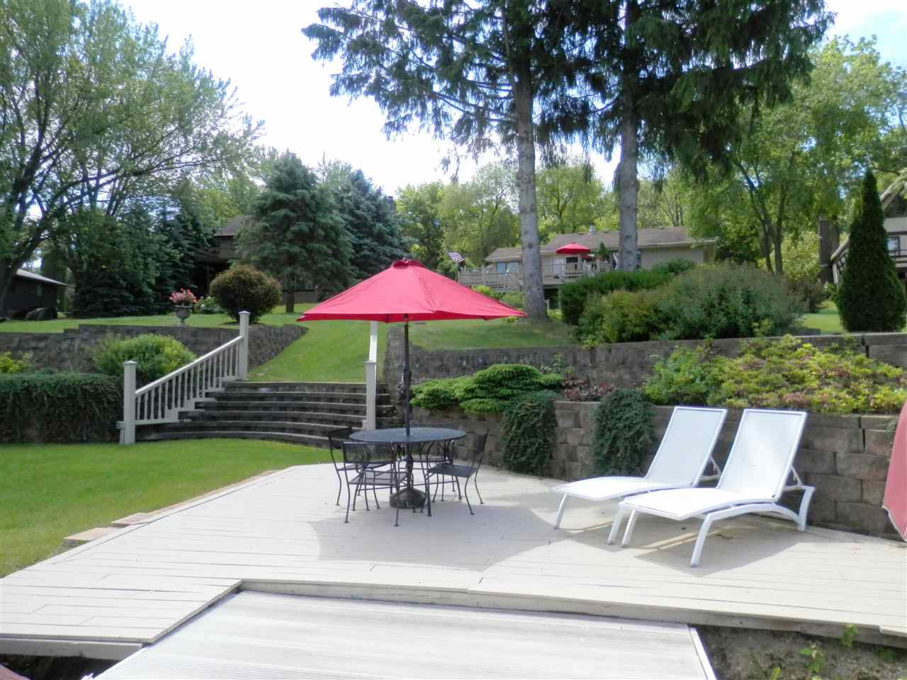 512 Baintree Road Lake Summerset, IL 61019 - Photo 7 of 25 a patio with a table and chairs under an umbrella