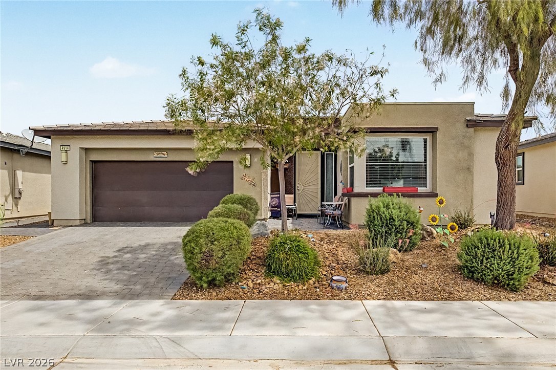 4914 East Beacon Ridge Drive Pahrump, NV 89061 - Photo 4 of 34 An inviting entry and manicured landscaping grace the front of this single-story home.