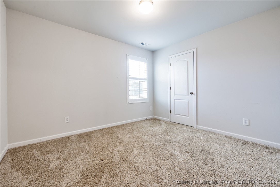 5918 Lowgrass Road Stedman, NC 28391 - Photo 21 of 32 an empty room with windows and closet
