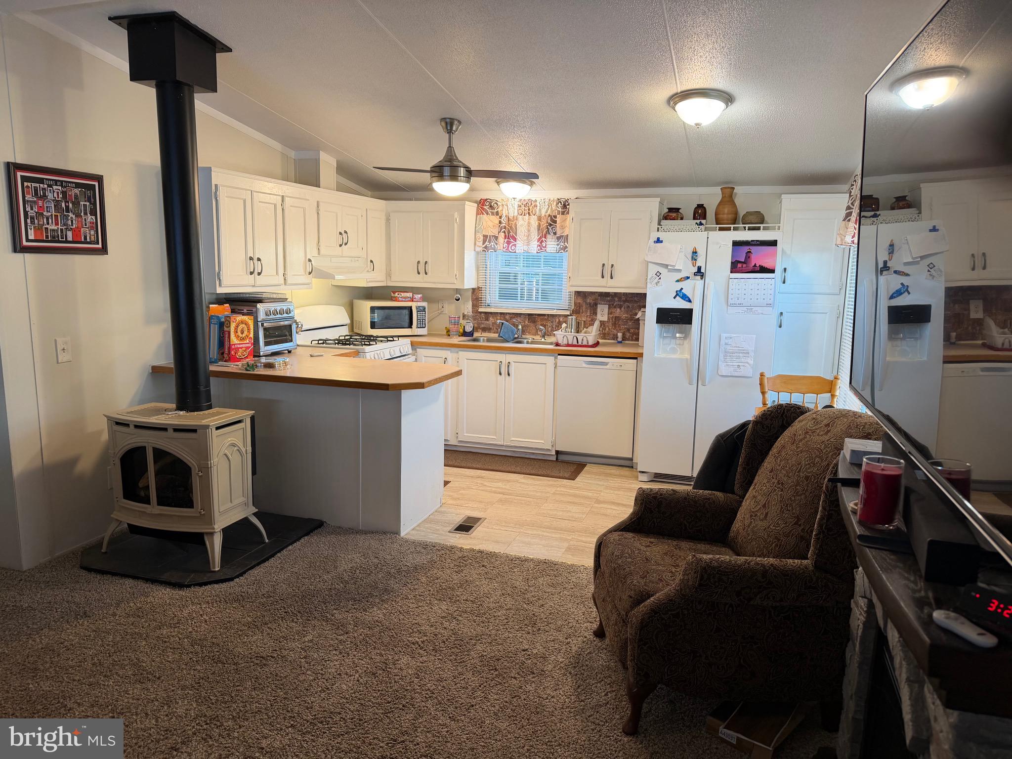 153 Whippoorwill Way Mantua, NJ 08051 - Photo 5 of 8 a living room with stainless steel appliances kitchen island granite countertop furniture and a kitchen view