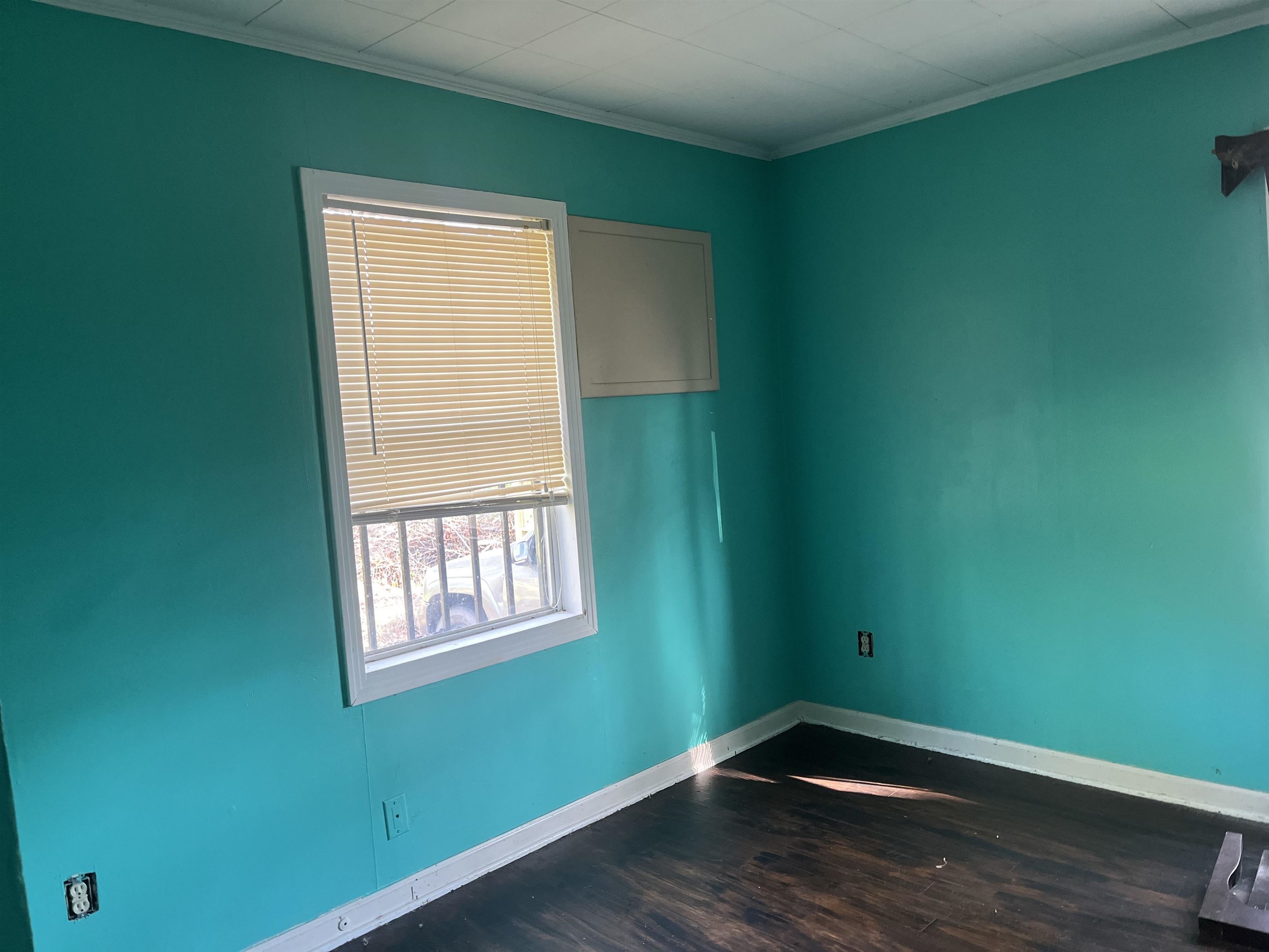 3382 Ardmore Street Memphis, TN 38127 - Photo 4 of 6 Empty room with baseboards, ornamental molding, and wood finished floors