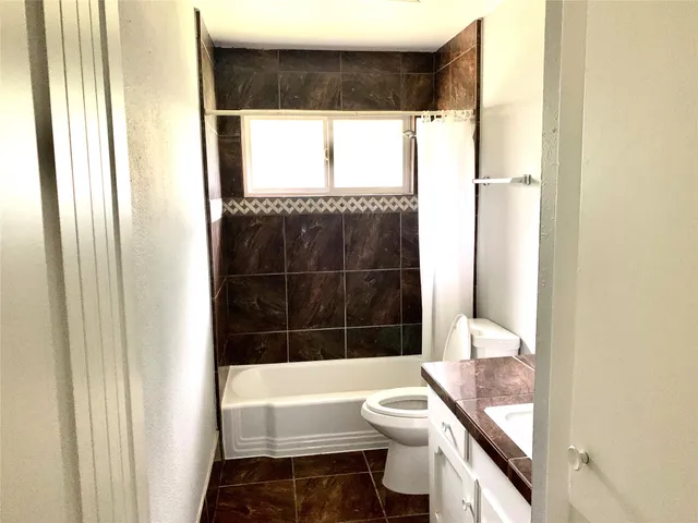 a bathroom with a toilet and a bathtub