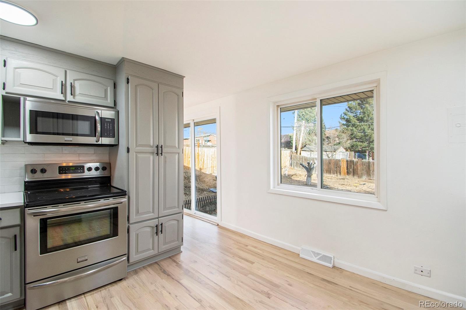 8360 Emerson Street Denver, CO 80229 - Photo 11 of 13 a kitchen with stainless steel appliances a stove microwave and refrigerator