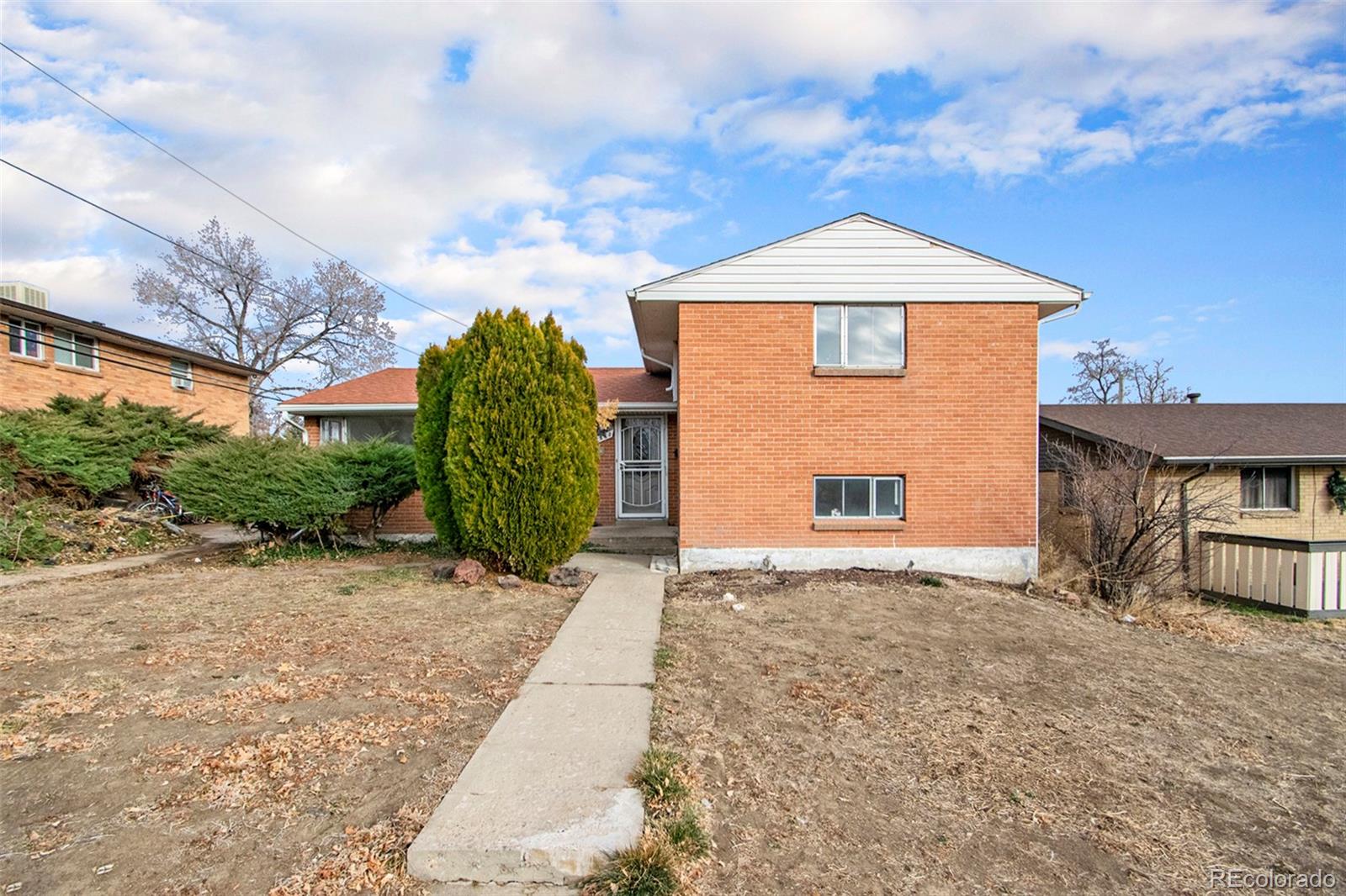 8360 Emerson Street Denver, CO 80229 - Photo 12 of 13 a front view of a house with a yard