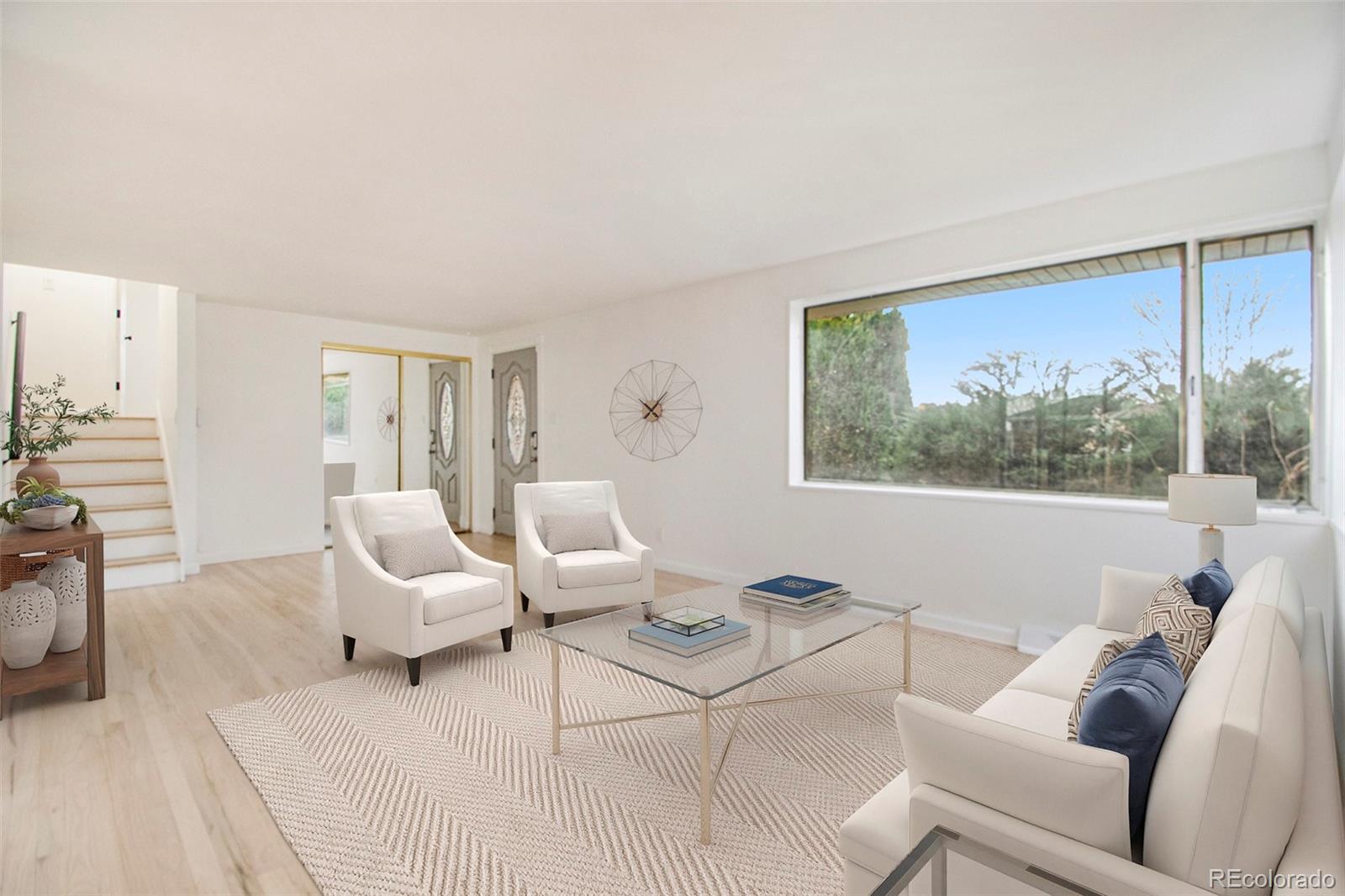 8360 Emerson Street Denver, CO 80229 - Photo 5 of 13 a living room with furniture and a large window