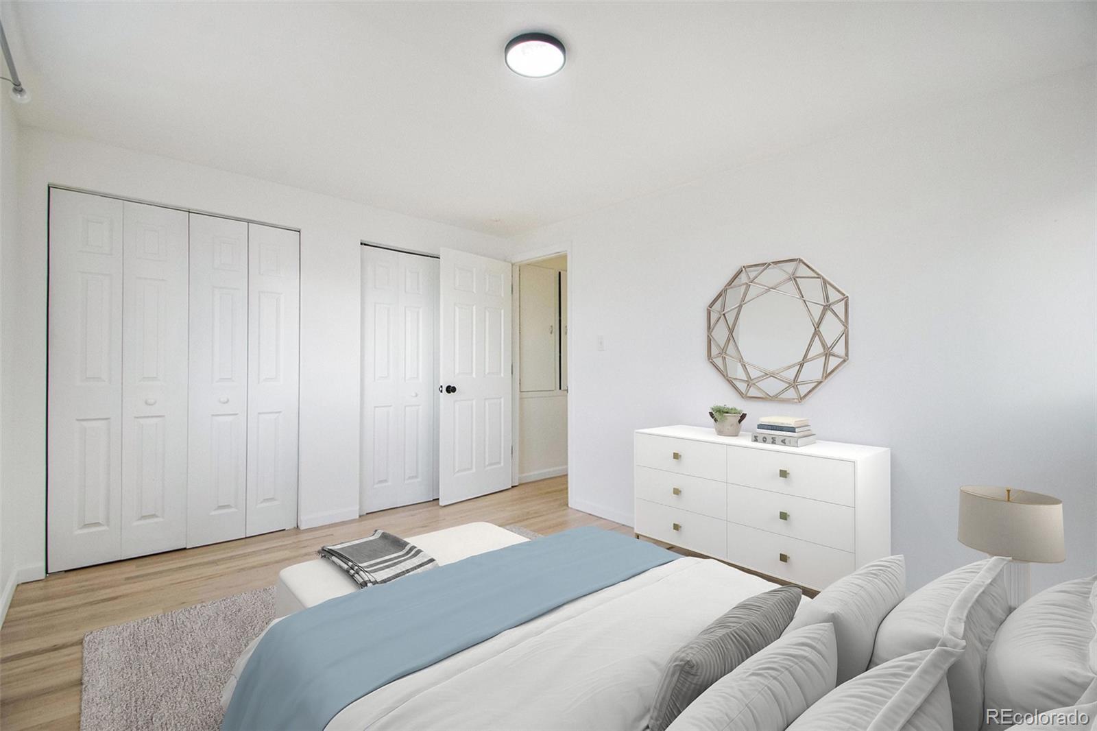 8360 Emerson Street Denver, CO 80229 - Photo 7 of 13 a bedroom with a bed and a chandelier