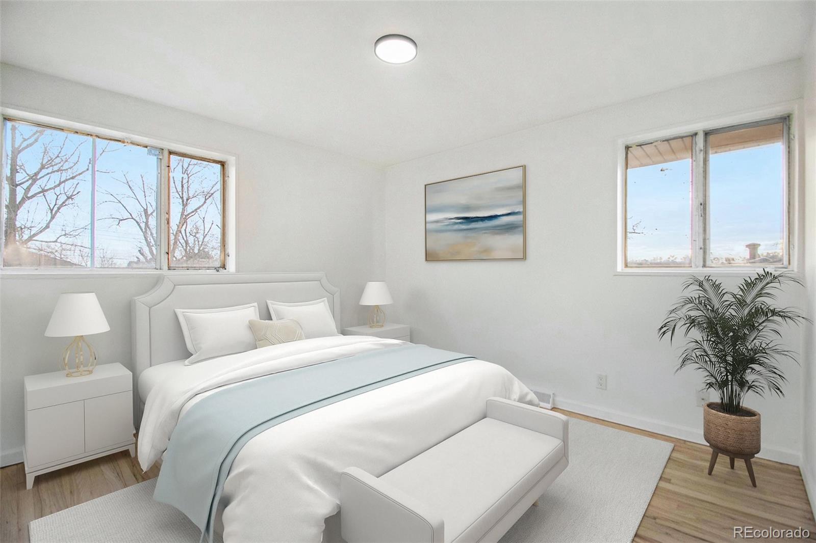 8360 Emerson Street Denver, CO 80229 - Photo 9 of 13 a bedroom with a bed and a large window