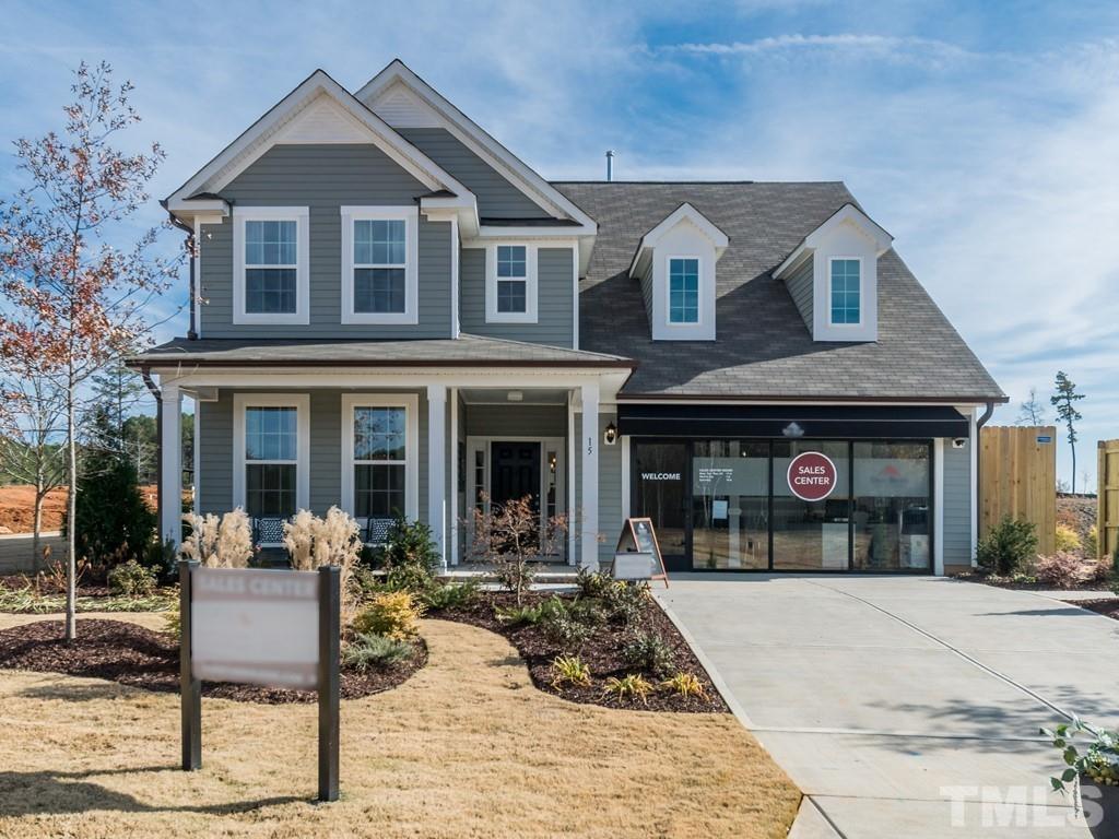 a front view of a house with yard porch and furniture
