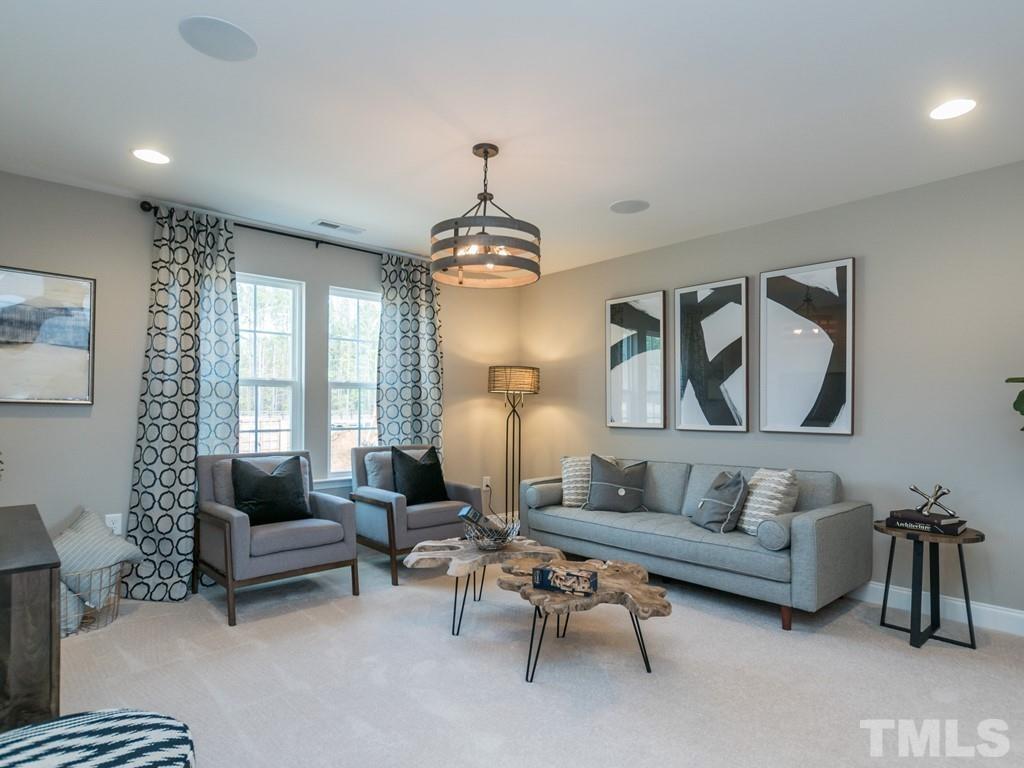 104 Red Cardinal Way Angier, NC 27501 - Photo 15 of 26 a living room with furniture and a chandelier