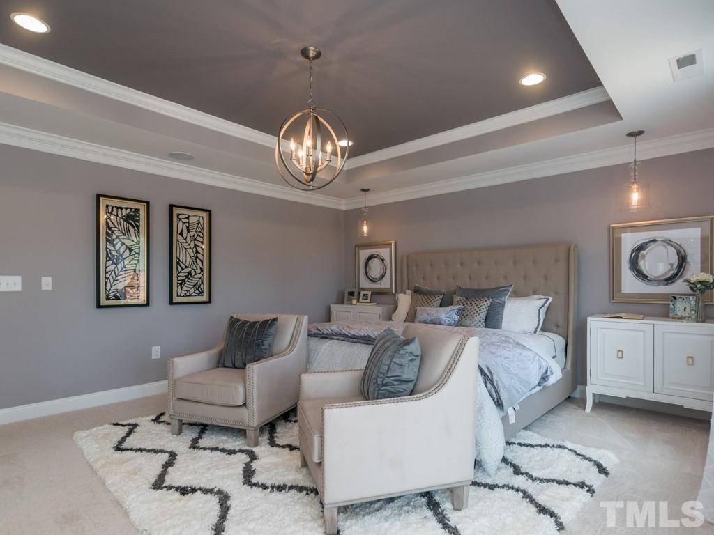 104 Red Cardinal Way Angier, NC 27501 - Photo 18 of 26 a living room with furniture and a chandelier