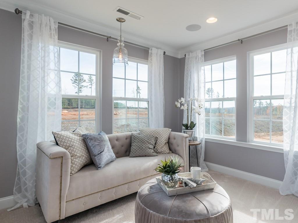 104 Red Cardinal Way Angier, NC 27501 - Photo 19 of 26 a living room with furniture and a large window