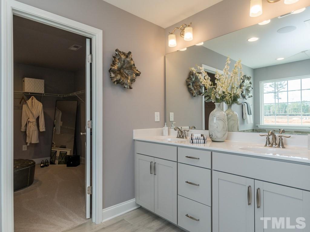 104 Red Cardinal Way Angier, NC 27501 - Photo 20 of 26 a bathroom with a double vanity sink and mirror