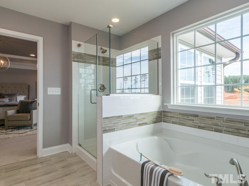 104 Red Cardinal Way Angier, NC 27501 - Photo 21 of 26 a spacious bathroom with a tub and shower