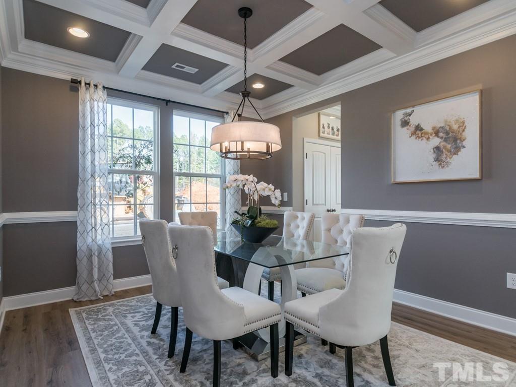 104 Red Cardinal Way Angier, NC 27501 - Photo 4 of 26 a dining room with furniture a chandelier and wooden floor