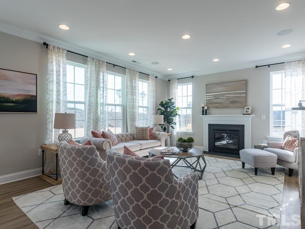 104 Red Cardinal Way Angier, NC 27501 - Photo 6 of 26 a living room with furniture a fireplace and a flat screen tv