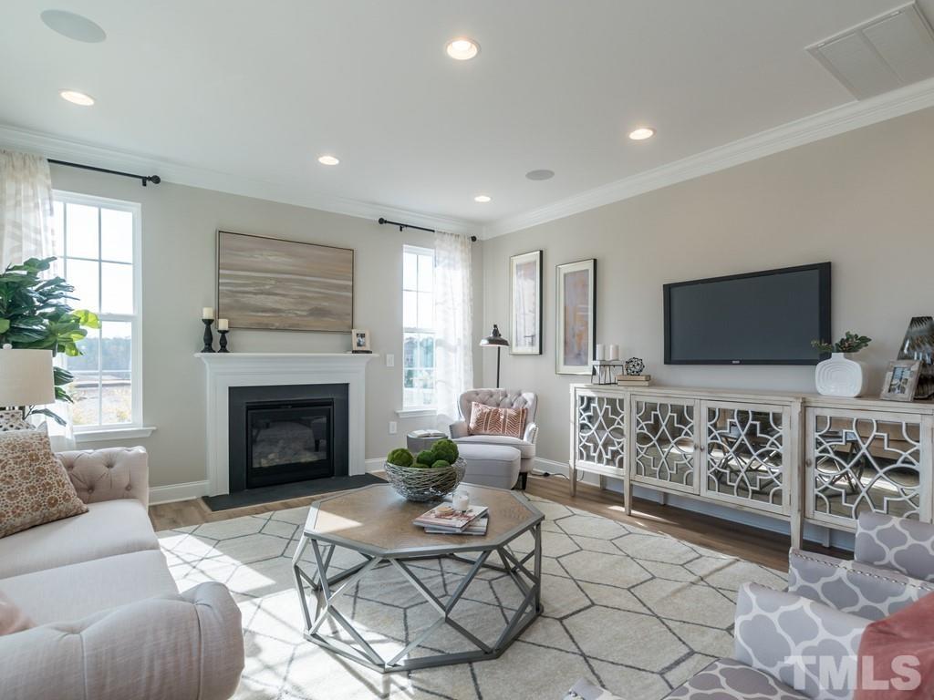 104 Red Cardinal Way Angier, NC 27501 - Photo 7 of 26 a living room with furniture fireplace and flat screen tv