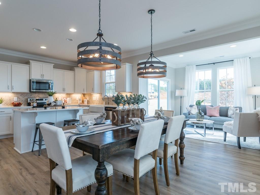 104 Red Cardinal Way Angier, NC 27501 - Photo 8 of 26 a dining room filled chandelier and wooden floor
