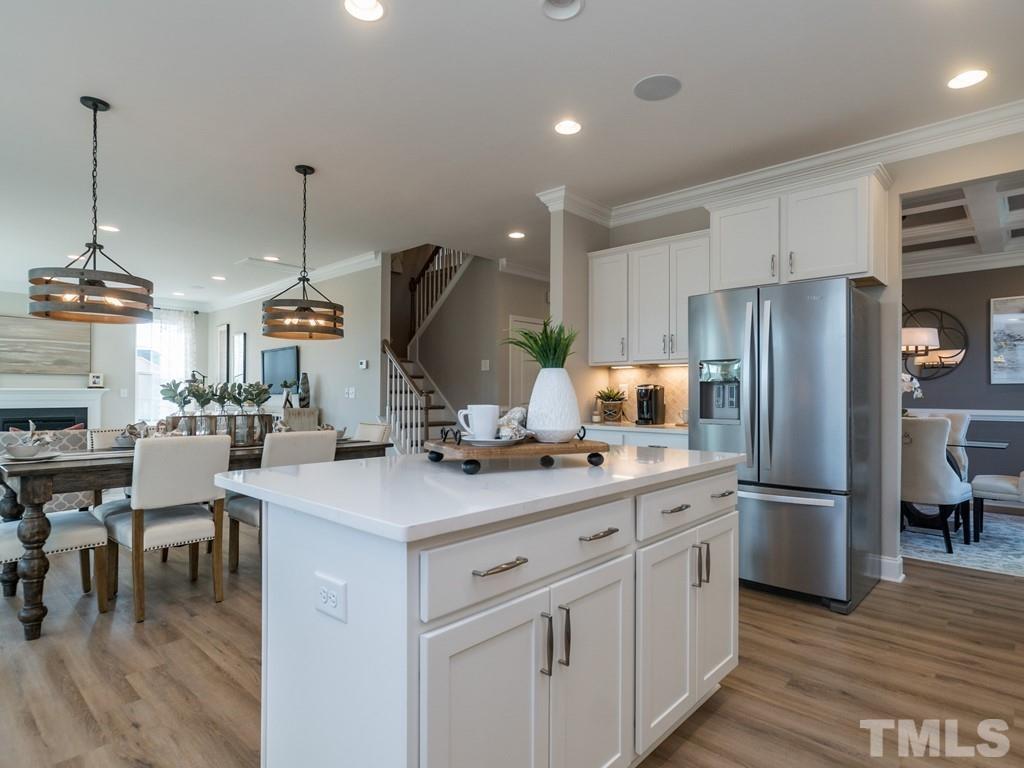 104 Red Cardinal Way Angier, NC 27501 - Photo 10 of 26 a kitchen with kitchen island a counter space a sink appliances and cabinets