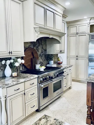 a bathroom with a granite countertop sink a mirror and shower