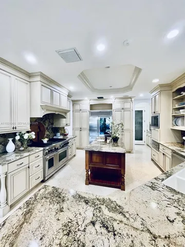 a kitchen with stainless steel appliances granite countertop a stove and a refrigerator