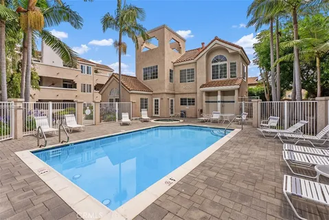 a view of a house with swimming pool and sitting area