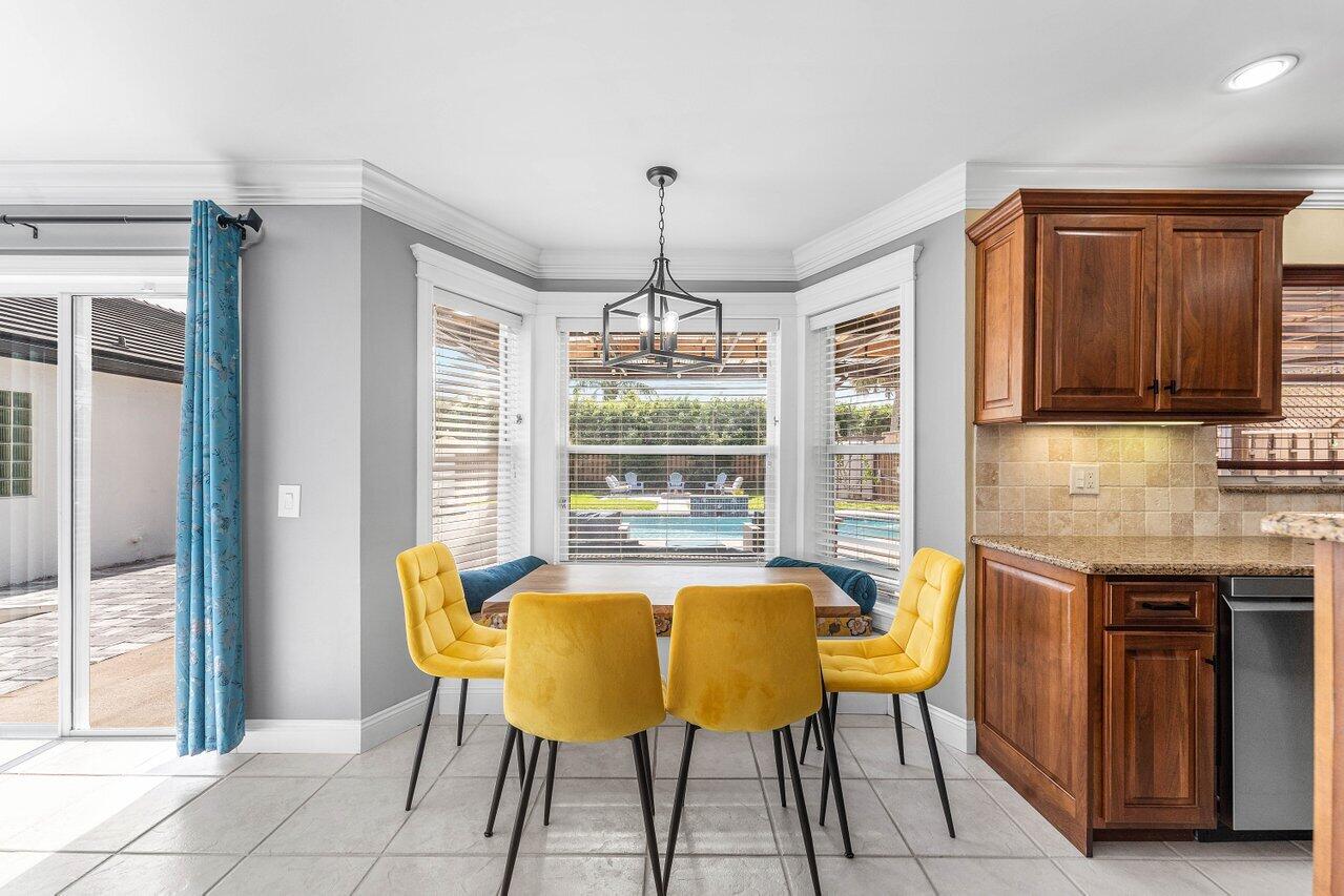 9434 Fox Trot Lane Boca Raton, FL 33496 - Photo 13 of 66 a view of a dining room with furniture window and outside view
