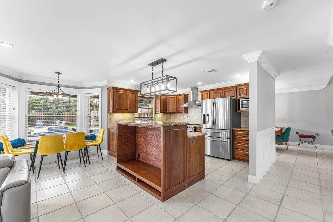 9434 Fox Trot Lane Boca Raton, FL 33496 - Photo 14 of 66 a kitchen with stainless steel appliances kitchen island granite countertop a refrigerator a stove a oven and a sink with granite countertops