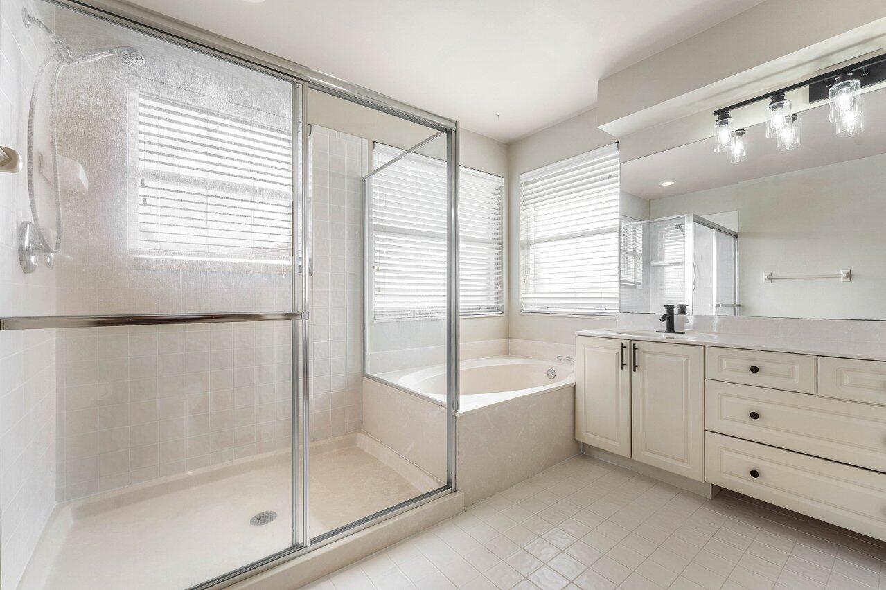 9434 Fox Trot Lane Boca Raton, FL 33496 - Photo 23 of 66 a spacious bathroom with a tub sink and mirror