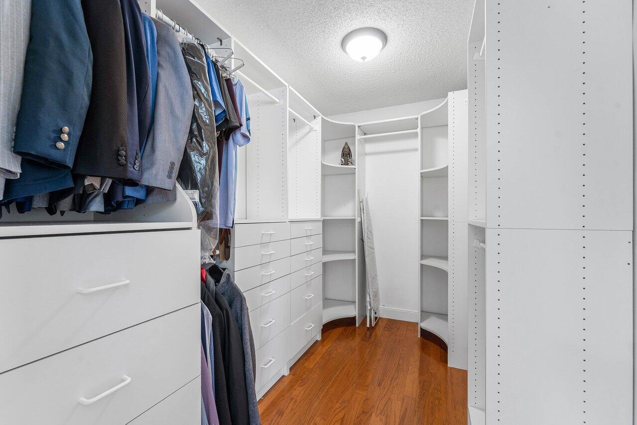 9434 Fox Trot Lane Boca Raton, FL 33496 - Photo 24 of 66 a view of walk in closet with clothes and shoes