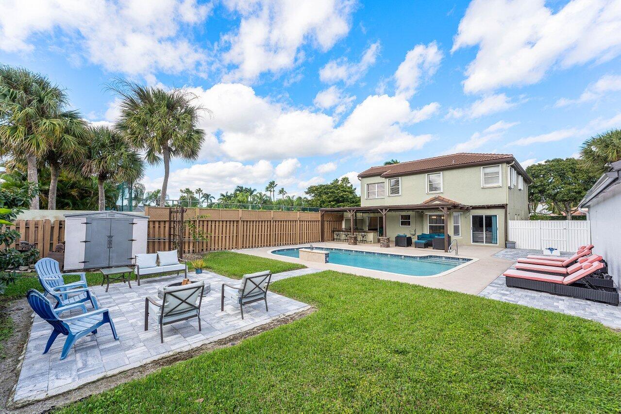 9434 Fox Trot Lane Boca Raton, FL 33496 - Photo 30 of 66 a view of a chair and table in the garden