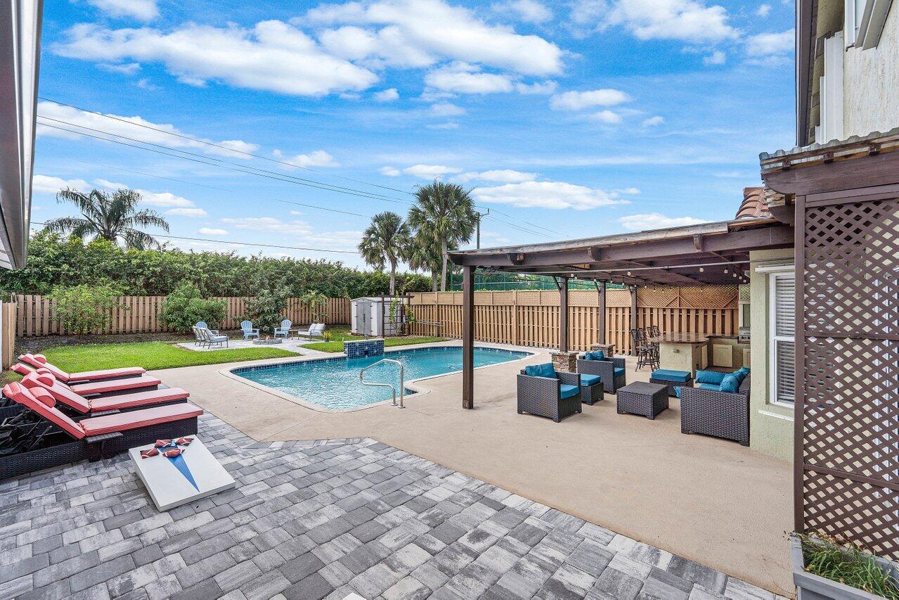 9434 Fox Trot Lane Boca Raton, FL 33496 - Photo 31 of 66 a backyard of a house with outdoor seating